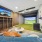 The recreation lounge at McDowell Point apartments in Naperville, IL, featuring a virtual golf simulator and couches.