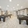 Resident lounge at McDowell Point apartments in Naperville, IL, featuring carpeted flooring and billiards tables.