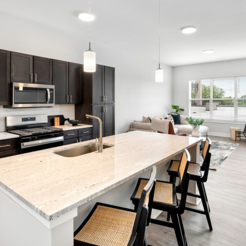 a kitchen with an island and chairs