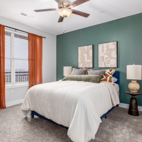 Model bedroom at McDowell Point apartments in Naperville, IL, featuring carpeted flooring and windows with blinds. Model bedroom at McDowell Point apartments in Naperville, IL, featuring carpeted flooring and windows with blinds.